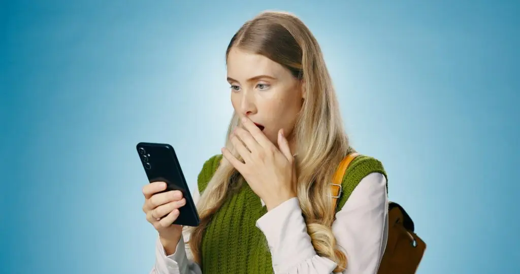 Travel scam, phone and text with shocked woman and fake news from phishing and reading spam in stud